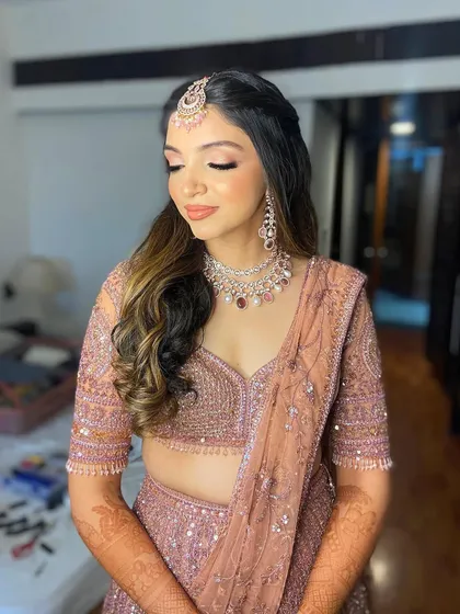 A close-up of Hetal's eye makeup, with her eyes closed to show the delicate blending of pink and champagne shadows.