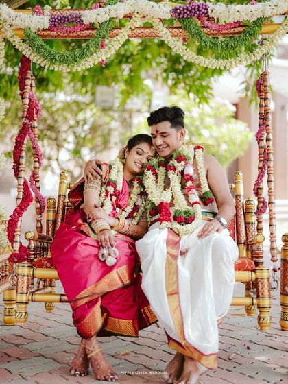 A beautiful moment of the couple resting on a floral swing (oonjal), a lovely tradition in many South Indian weddings.