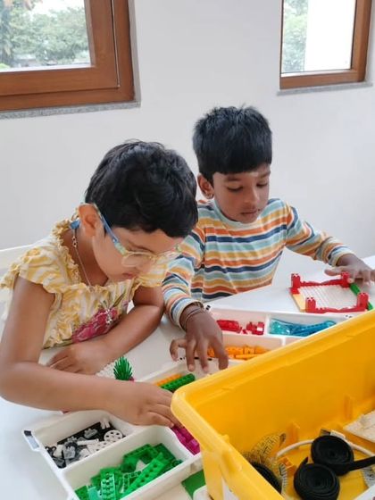 Two young students collaborate on their LEGO build during our weekend program at the Whitefield center.
