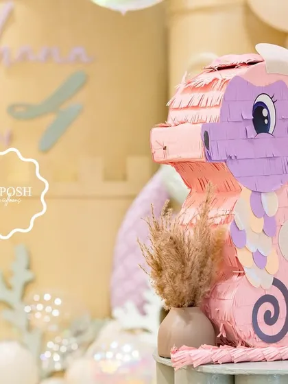 A cute seahorse piñata, ready to be filled with treats for a fun party game.