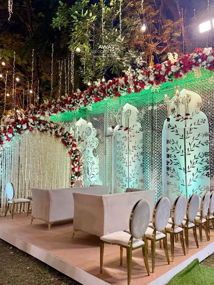 A wider view of the Nikah stage, showing the elegant seating for the family and the beautiful overhead floral runner.