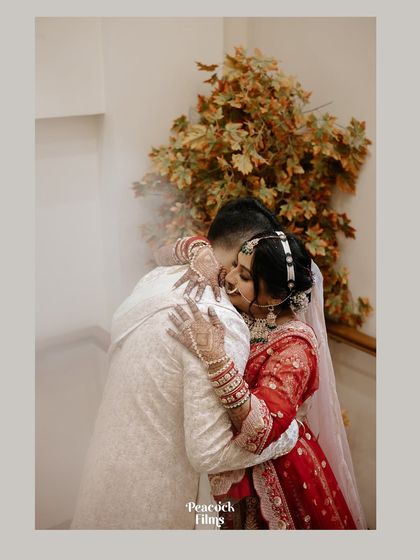 A tender hug between the bride and groom, a quiet moment of connection and reassurance amidst the grandeur of the wedding ceremony.
