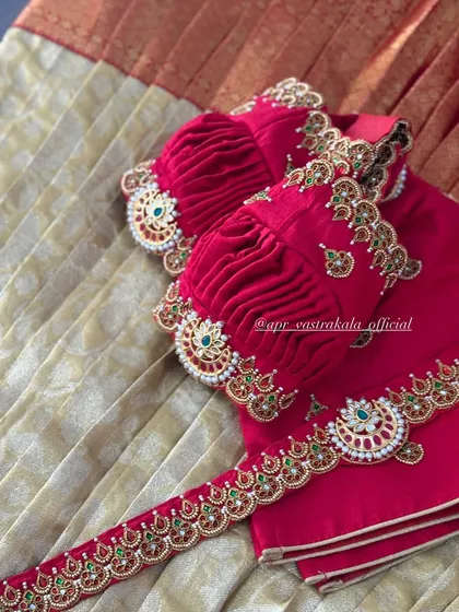 A detailed shot of the ruched puff sleeves, finished with an embroidered cuff that mimics a traditional arm cuff or 'vanki'.