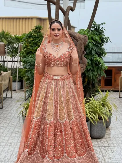 A confident and poised full-length shot of the bride. Her makeup enhances her features, making her look like the best version of herself on her wedding day.