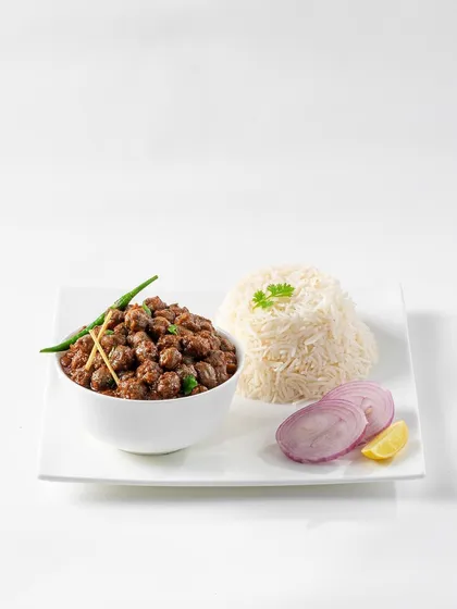 A simple, elegant shot of Chole Chawal. The focus is on the food itself, with minimal props, making it a versatile image for menus, websites, or any platform requiring a clean food presentation.