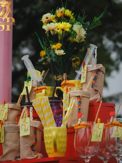 More details from our Haldi bar. We use natural materials like jute bags for glasses and fun, colorful straws to create a rustic and festive look.
