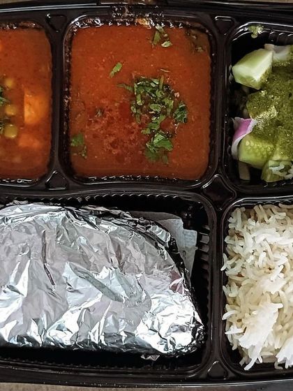 A flavorful thali with rajma and matar paneer. The combination of kidney beans and paneer in a tomato gravy is a North Indian classic.