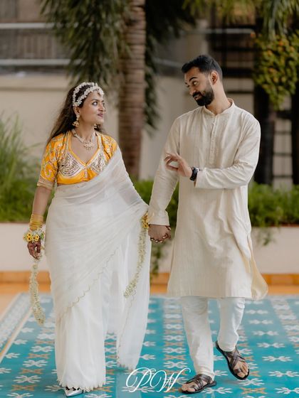 A splash of yellow. This elegant couple shares a quiet moment during their Haldi celebration in Goa, looking effortlessly chic.