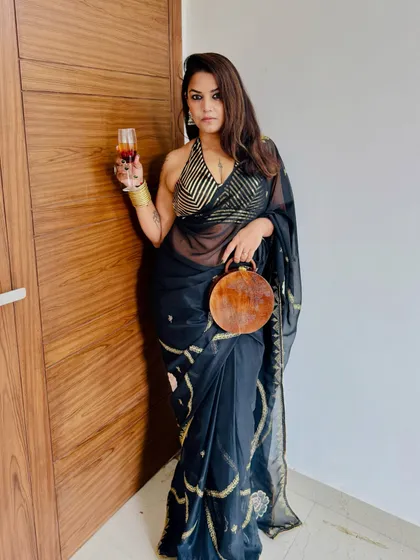 A stunning cocktail look for a magical evening. This client is rocking our black and gold striped halter blouse with a beautiful black saree.