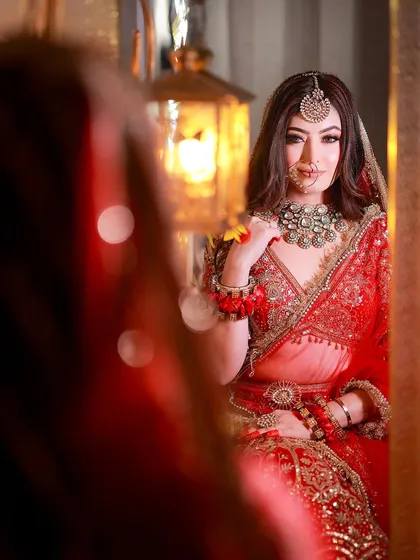 A beautiful reflection shot with warm lighting, creating an intimate and artistic bridal portrait.