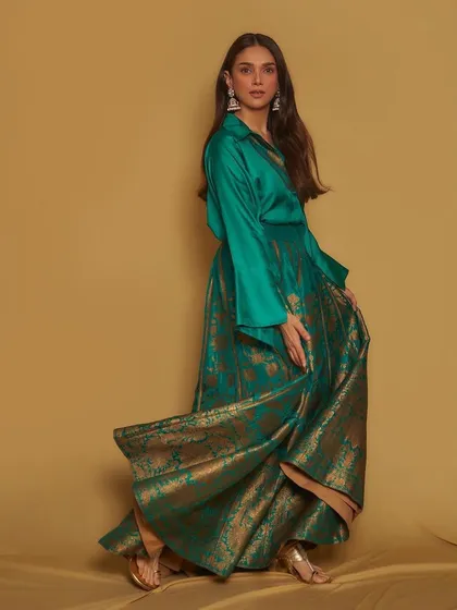 I love a powerful fusion look, and this Payal Khandwala ensemble is a perfect example. The combination of a rich emerald green silk shirt with a flowing brocade skirt is modern, regal, and guaranteed to turn heads.