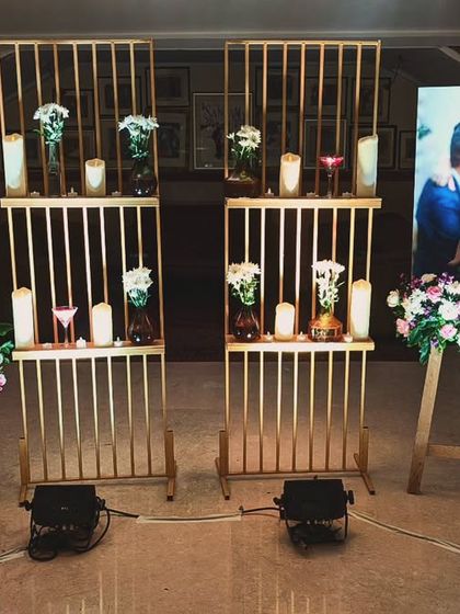 A beautiful way to share a love story. I created this gallery wall with the couple's photos on easels, interspersed with candles and floral arrangements, making the decor deeply personal and engaging.