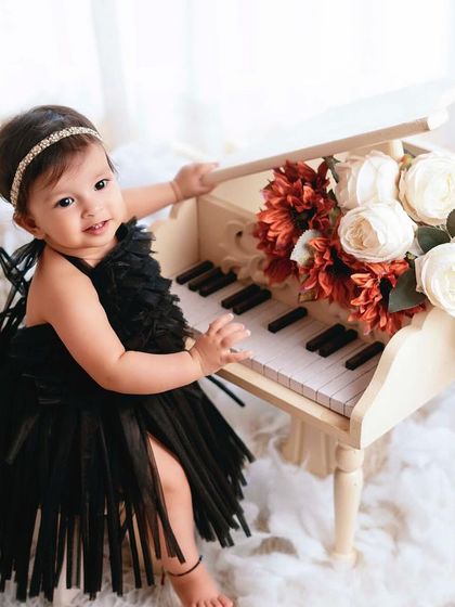 A little musician in the making. This dreamy setup with a miniature piano and fluffy clouds is perfect for a magical and elegant portrait.