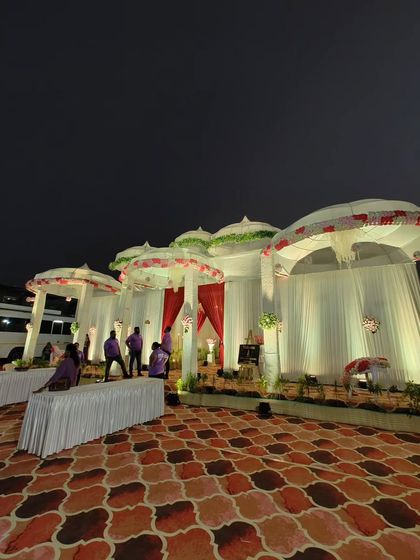 A side view of the traditional dome-style setup, showing the unique umbrella-like structures that form the venue's facade. The design provides both an open feel and a sense of enclosure.