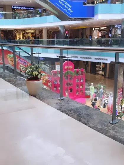 A wide shot showing how the spaced-out planters create a green through-line in the mall without obstructing foot traffic. This strategic placement enhances the environment for all visitors.