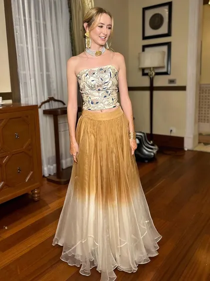 The sister of the bride looking chic and happy in her modern, indo-western outfit. The full-length view shows how her hair and makeup complete the stylish ensemble.