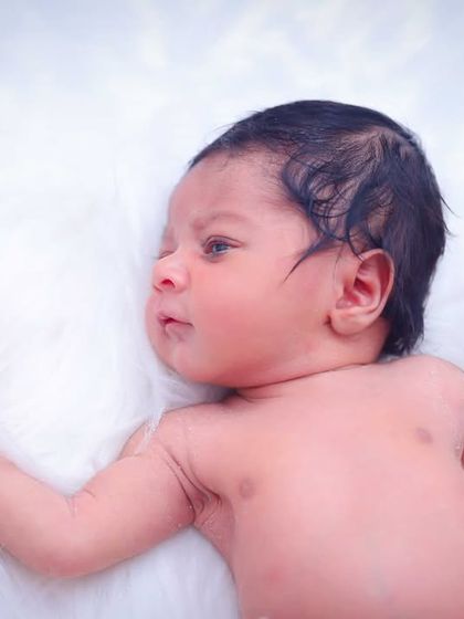 A portrait of a newborn baby, awake and looking around. We take our time to capture your baby's first expressions and delicate features on a soft, comfortable surface.