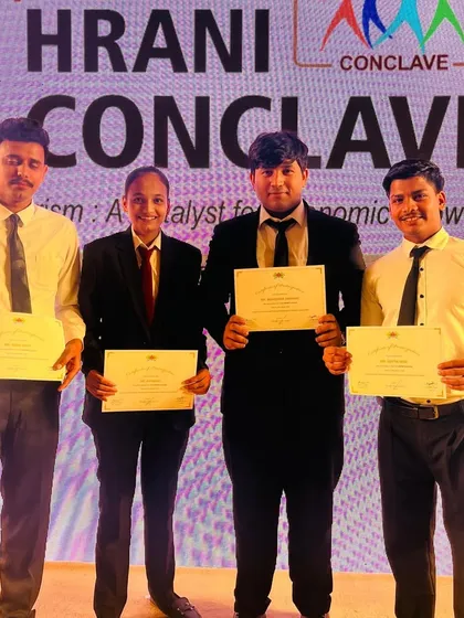 Four of our students proudly display their participation certificates. Volunteering at such events helps build their resumes and provides crucial networking opportunities with industry professionals.