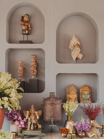 A collection of handpicked figurines and artifacts displayed in wall niches, adding character and a sense of history to the decor.