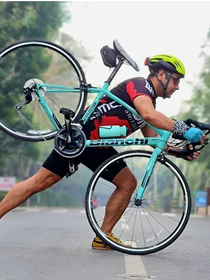 A member showing his strength by lifting his Bianchi bike. It's a classic cyclist pose that we love.