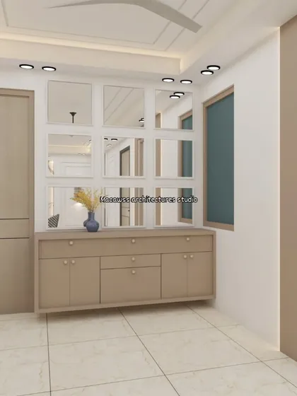 This foyer design combines storage and style with a floating console and a grid of mirrors that makes the space feel larger and brighter. The neutral beige and white palette is calm and welcoming.