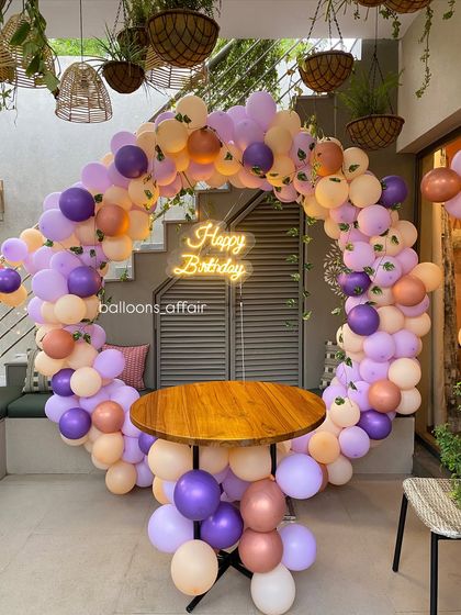 A full view of the pastel balloon arch, designed to frame a small table for cake cutting or as a standalone photo spot.