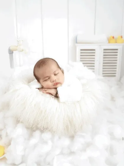 A peaceful moment from our bubble bath theme. The baby sleeps on a fluffy white cloud, with a miniature tap and rubber ducks creating a whimsical bathroom scene.