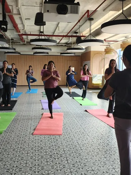 For teams with dedicated space, I offer on-site mat yoga classes like this one at Johnson & Johnson. We work on balance and focus with poses like Vrikshasana (Tree Pose), building both individual stability and collective calm.