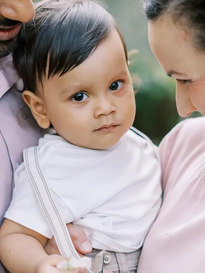 A close-up of a one-year-old's expressive face. The time before they start walking is perfect for these squishy, huggy shots.