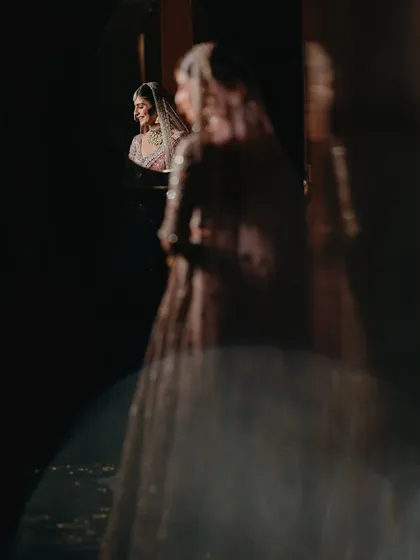 An artistic reflection shot of the bride. Capturing her reflection in a mirror adds a layer of depth and introspection to this beautiful and creative bridal portrait.