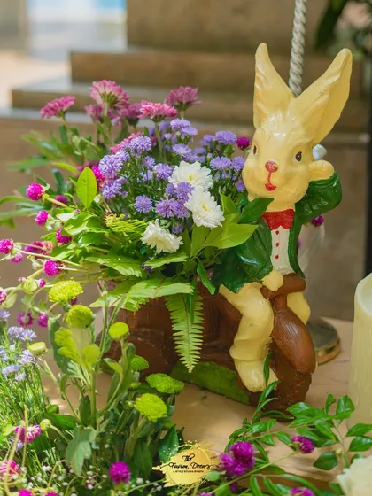 A whimsical detail from the baby shower decor. This cute rabbit figurine, nestled in a floral arrangement, adds a touch of storybook charm to the celebration.