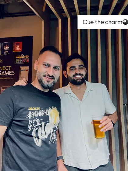 Cue the charm. A couple of friends enjoying the vibe at our Karaoke Friday, where you can sing, play, and connect.
