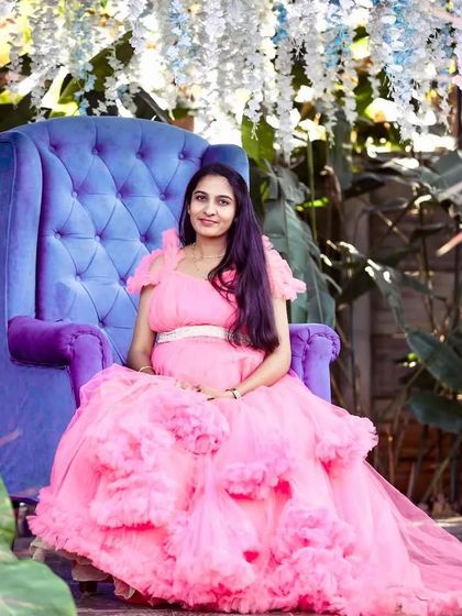 A regal maternity portrait. The client is seated on a throne-like chair, looking absolutely majestic in my pink ruffled ball gown.