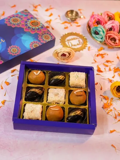 My Diwali hampers are all about celebrating with a mix of modern and traditional sweets. This spread shows a curated box of my fusion treats, including chocolate bars and assorted mithai-inspired desserts.