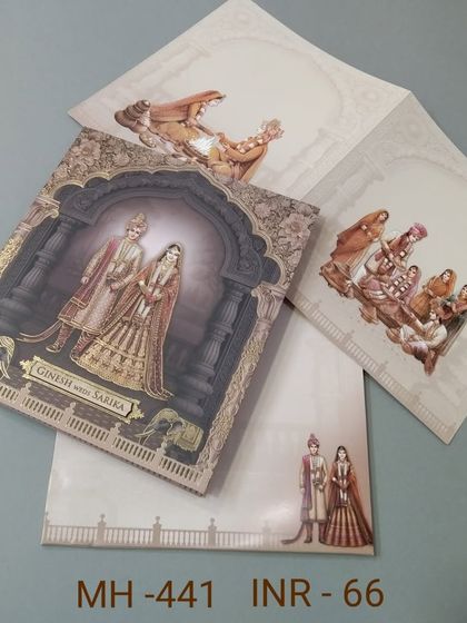 A grand invitation featuring a royal couple under a beautifully decorated arch. The card has a 3D quality and includes inserts with matching traditional artwork.