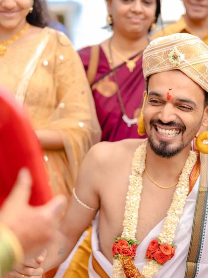 Wedding traditions are often filled with so much fun and laughter. The groom's genuine smile during this ritual is a perfect example of the candid, happy moments I love to photograph.