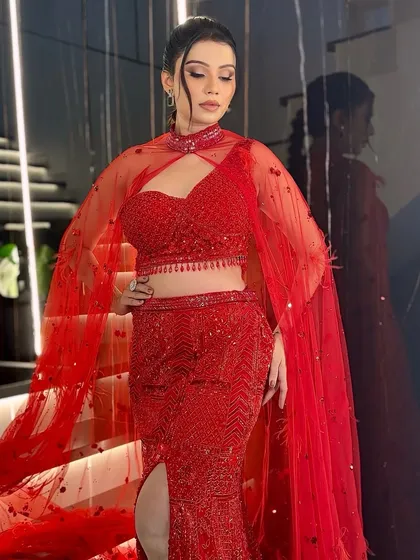 Serving sparkle and sophistication. This full-length shot shows how a sleek hairstyle and glamorous makeup can perfectly complement a statement red gown.