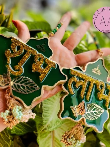 My handmade resin Shubh Labh hangings are designed to welcome prosperity into your home. This green pair features sparkling glitter lettering and delicate leaf and butterfly accents.