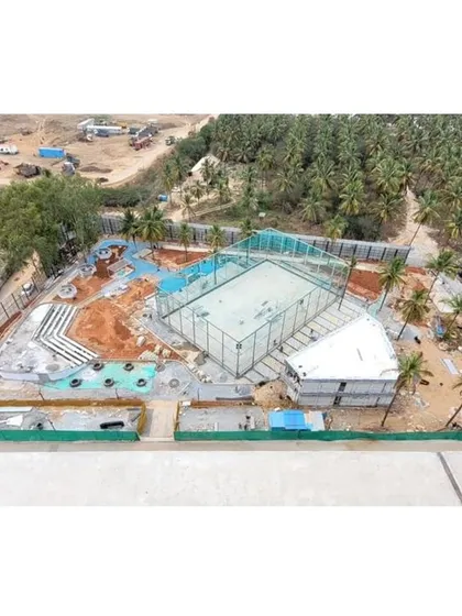 An earlier construction photo of the VTS site, with the basic structure of the sports court and surrounding palm trees in place.