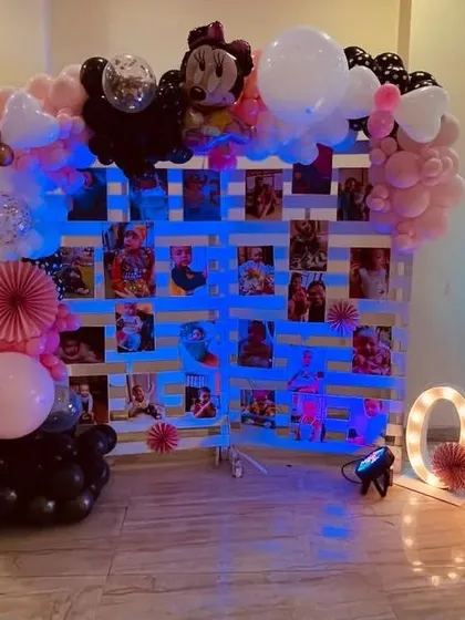 A Mickey and Minnie Mouse theme with a photo memory wall, marquee letters, and character cutouts.