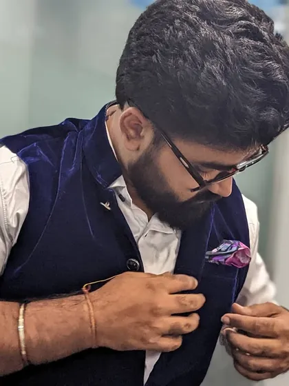 Adjusting my pocket square. The small details complete the look.