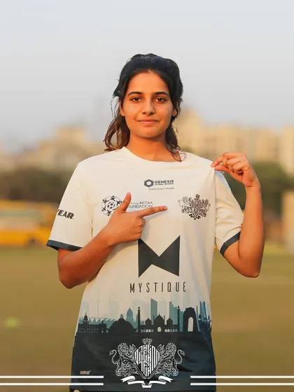Pointing to her team. This player acknowledges the collective effort that leads to victory.