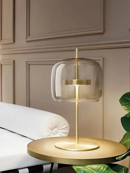 This iconic antique brass table lamp features a beautiful glass shade that creates a warm, diffused glow. Its elegant design makes it a perfect centerpiece for a side table or console.