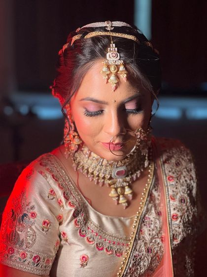 A beautiful Marwadi bride. We opted for a soft pink eye makeup to complement her ivory and pink lehenga, creating a look that is both traditional and delicately romantic.