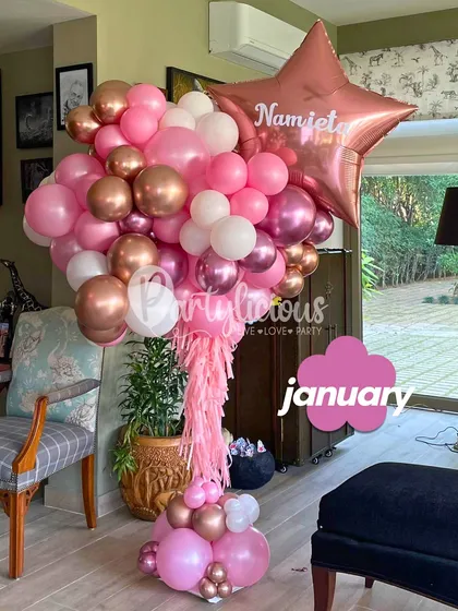 A beautiful, personalized balloon bouquet in shades of pink and rose gold. The custom name on the star balloon adds that special touch to make the birthday girl feel celebrated.