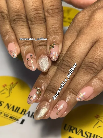 A delicate and dreamy manicure featuring a soft pink base with gold accents. I added personalized initials, a tiny ring charm, and a sprinkle of glitter for a charming and romantic feel.