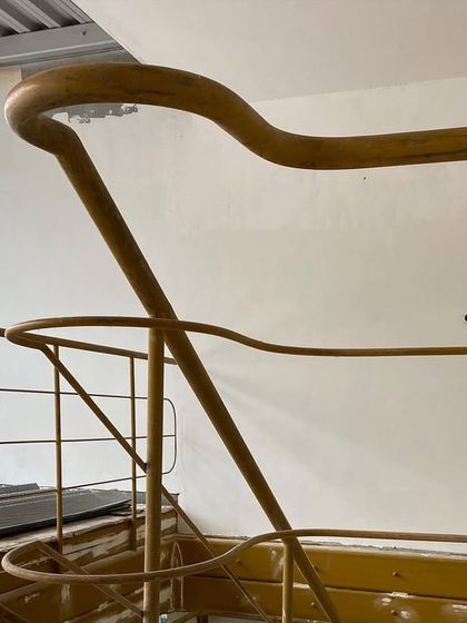 The elegant curve of a handrail, a small detail that speaks to the overall design intent. Craftsmanship and thoughtful design are evident in every element, from the grand structural changes to the parts people interact with daily.