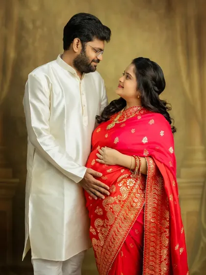 The love in your eyes says it all. This couple's portrait in traditional attire is a beautiful celebration of your journey to parenthood, blending culture with the excitement of what's to come.