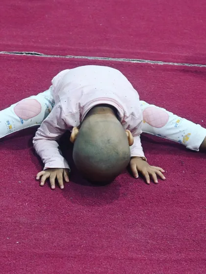 Flexibility is key in gymnastics. This little one is working on their middle split stretch, building a strong foundation for the future.
