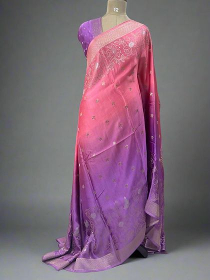 A beautiful shaded satin saree, blending from pink to purple with a floral border.